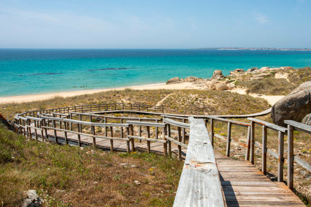 Wooden railing to access a beach near Betanzos in Galicia in Spain and sunbathe in the Atlantic Oceanの写真素材