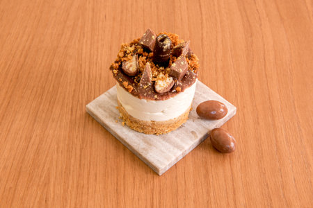 Mini chocolate cheesecake with sprinkles of different kinds of chocolate on a gray marble plate