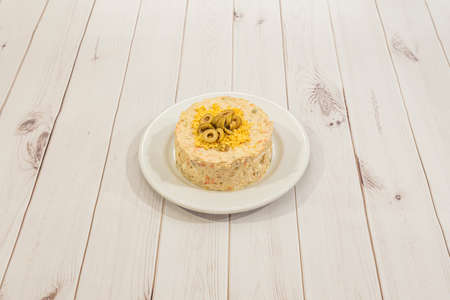 Russian salad with boiled egg, Malaga olives, mayonnaise, carrot, boiled potatoes and peasの写真素材