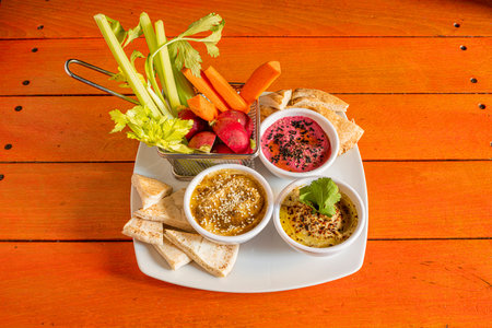 Fantastic vegetarian dish with hummus of three different flavors, pieces of unleavened bread and...