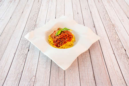 Italian spaghetti with bolognese sauce with minced meat on a nice white plateの写真素材