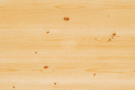 Pine wood table top varnished in transparent color to highlight the beauty of its knots and veins.の写真素材