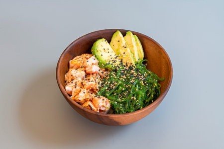 Delicious Hawaiian poke bowl of wakame seaweed salad with flambÃ©ed salmon, chopped Mexican...