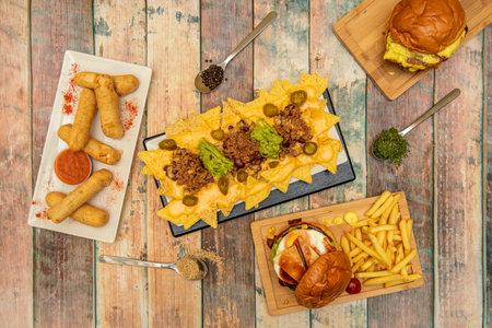 Latin dishes and fast food burgers, tequeÃ±os with salsa and pienton, nachos with guacamole and...