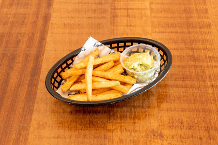 Fried yucca cut with chips with guacamole for dipping