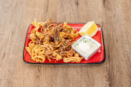 delicious tapa of squid squid battered and fried with olive oil with light mayonnaise and lemon juice to garnishの写真素材