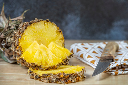 wonderful ripe pineapple cut in half, slices and chunks ready to peck. Ripe fruit chopped by a...