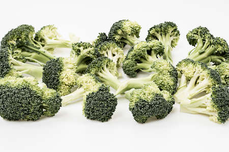 raw green broccoli branches on white backgroundの写真素材
