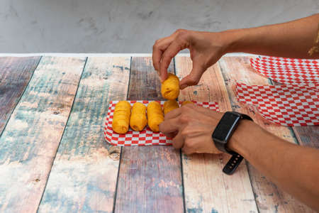 Chef's hands placing corn flour tequeÃ±os for the photoの写真素材