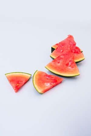 Triangular seedless watermelon chunks on light colored tableの写真素材