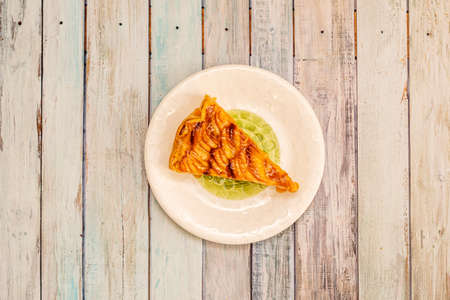 Top view image of apple pie portion with sliced roasted apple and jam with apple syrupの写真素材