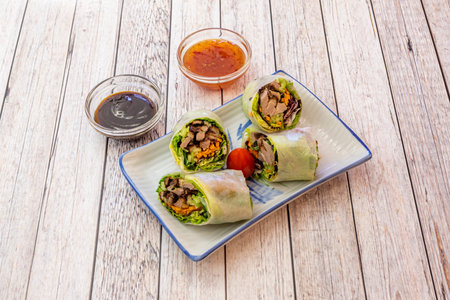Fried Roast Duck Rolls with Lettuce, Carrots, Zucchini, Cherry Tomatoes and Dipping Sauces