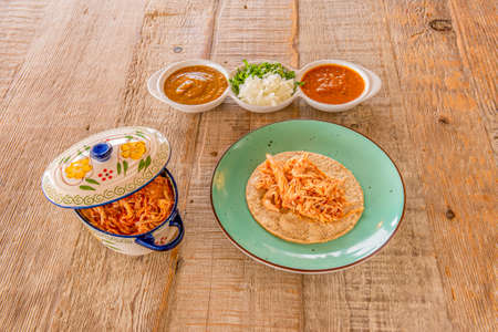 Casserole tart with chicken tinga stew and tinga taco with wheat tortilla and dipping saucesの写真素材
