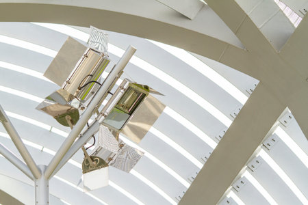 Directional metal lamps on the ceiling of a metal walkway