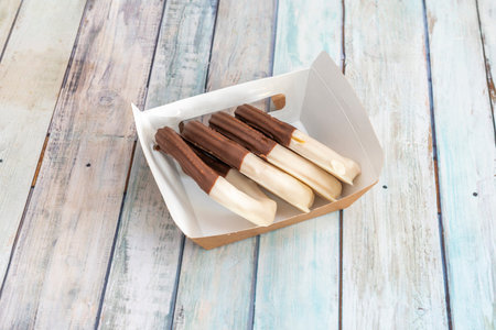 Churros ration with two chocolates on a home delivery containerの写真素材