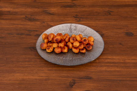 Madrid tapas of patatas bravas on dark wooden tableの写真素材