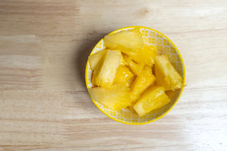 Top view image of yellow bowl with pieces of pizza for fruit snackの写真素材