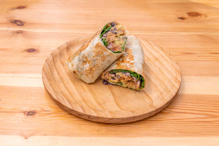 tex mex wrap with pico de gallo, lettuce, bean stew and cream cheese with the fried tortillaの写真素材