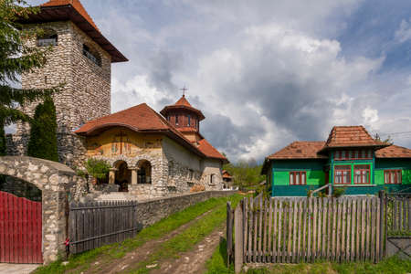 Vintage houses and church of a village in the Romanian mountains of Transylvania in the Carpathiansのeditorial素材