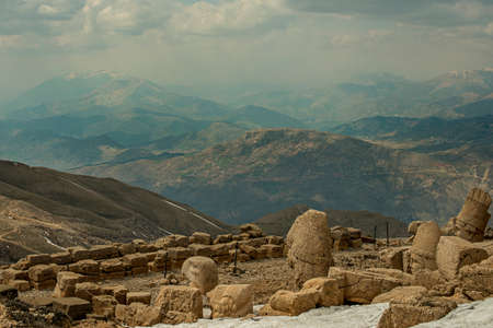 Heads of gods and mythological figures on top of the mountain of the gods with views of the surrounding peaksの写真素材