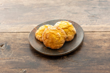 Delicious trio of lemon cookies with glass sugar on vintage wooden tableの写真素材