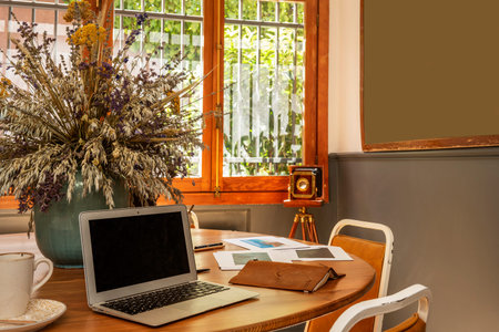 Vintage wooden work table with vase of flowers in a coworking space
