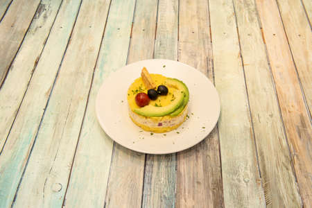 Peruvian potato cause cooked with black olives, ripe avocado and red onion with mayonnaiseの写真素材