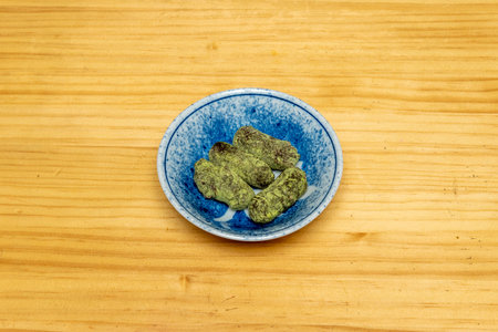Truffle chocolates with matcha tea on a small blue bowl
