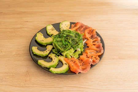 Japanese wakame seaweed salad with Mexican avocado and smoked Norwegian salmonの写真素材