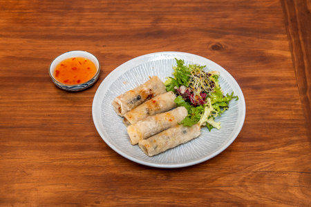 Vietnamese nems, a simple, exotic and crunchy bite of rice paper wafer stuffed with prawns with...