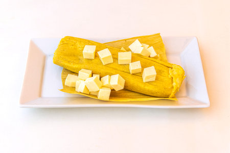 Humita with cheese basically in a pasta or corn dough lightly seasoned, wrapped and finally cooked or toasted in the leaves of an ear of corn.の写真素材