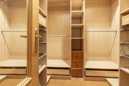 Wardrobe interior with its wooden divisions and bars for hanging clothesの写真素材