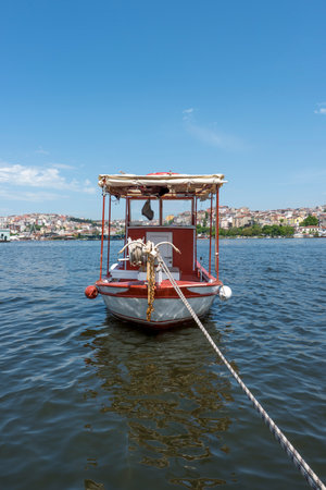 Fisherman's raft moored in the waters of the shore of the Golden Horn in Istanbulの写真素材