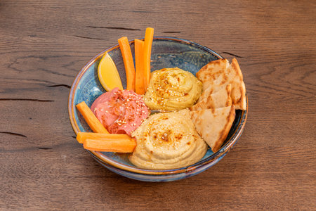Hummus is a cream of chickpeas cooked with lemon juice, which includes tahini paste and olive oil,...