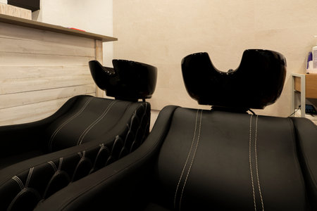 Armchairs for washing hair in a traditional barbershopの写真素材