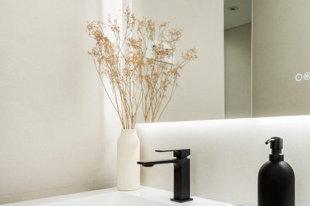 Modern bathroom with white glass countertop, black taps, recessed mirror with anti-bath and...