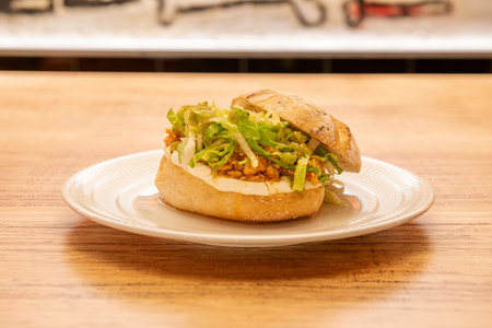 Chicken tinga sandwich made with shredded meat in a sauce based on tomato, onion, garlic and chipotle chiliの写真素材