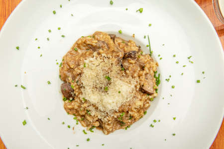 Delicious traditional Italian recipe, with creamy rice flavored with mushrooms, a touch of Parmesan cheese and truffleの写真素材