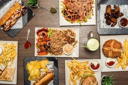 Set of fast food dishes, sandwiches and burgers, french fries, barbecue wings, basmati rice, salad...