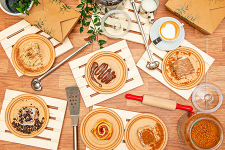 Set of wooden plates with condiments and utensils for cooking cinnamon roll with chocolate, a lot of cinnamon, chocolate chips, ham and cheeseの写真素材
