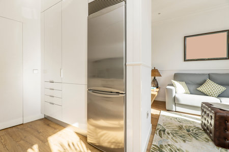 Apartment with kitchen open to living room with sofa and side table
