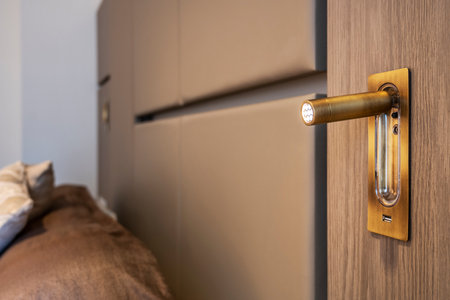 Design lamp in brass with usb connection in the headboard of a bedroomの写真素材