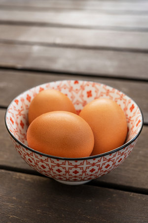 Fresh brown eggs in a beautiful bone china bowl