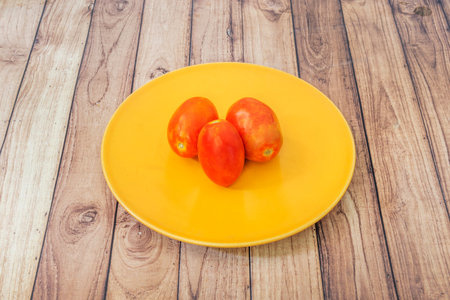 low casein red color, variable in size, from 3 cm in diameter to 16 cm, with seeds within a fleshy pericarp developed from an ovaryの写真素材