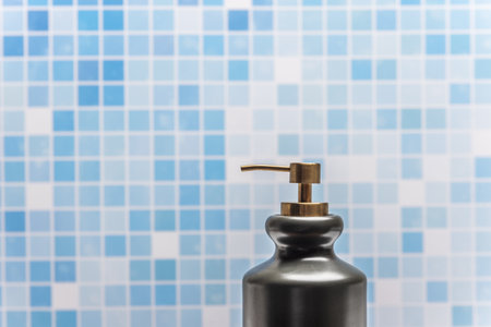 A black porcelain container with a dispenser for hand washing soapの写真素材