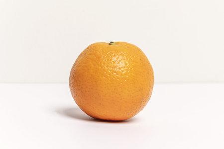A delicious whole orange with its characteristic rough skinの写真素材