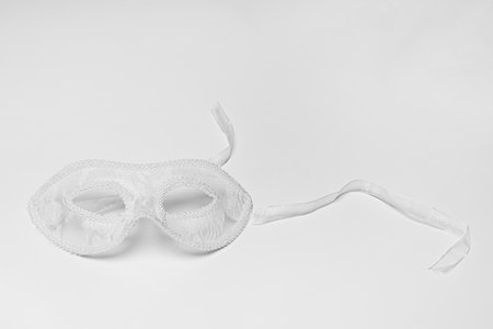 White lace masks on a white surfaceの写真素材