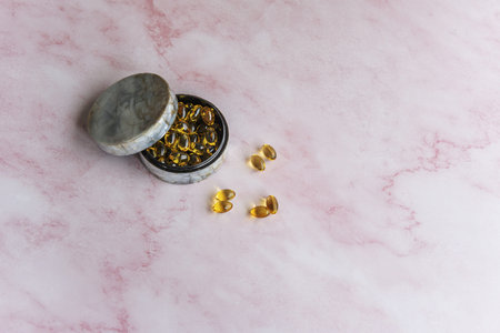 A mother-of-pearl pillbox with pearls of nutritional supplements