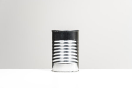A can of canned fast food with a white background on a smooth white surfaceの写真素材