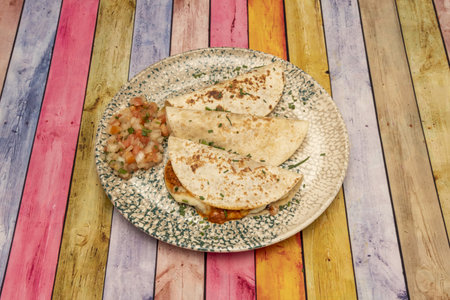 The quesadilla is a Mexican dish that consists of a corn or wheat tortilla folded in half that, depending on the region, can be filled with cheese or other ingredients.の写真素材